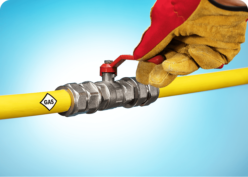 Gloved hand turning gas valve on pipe.