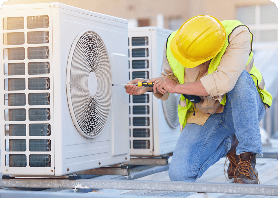 Technician repairing rooftop air conditioning unit.