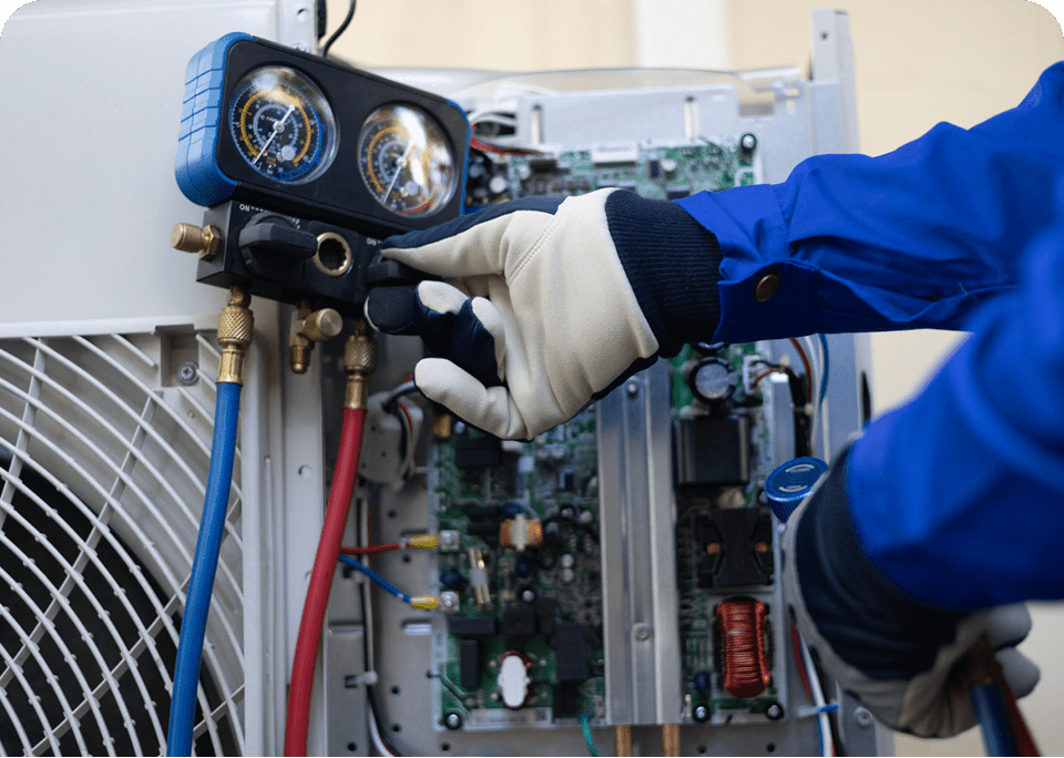 Technician checking air conditioning unit gauges.