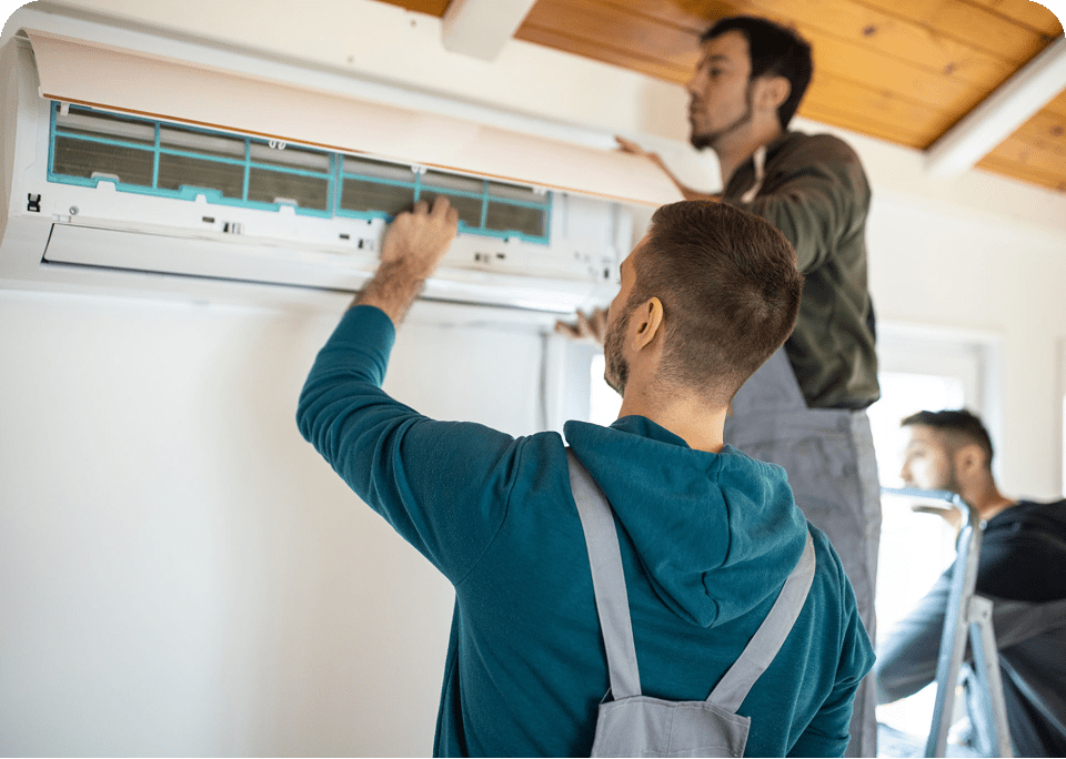 Men installing a wall-mounted air conditioner.