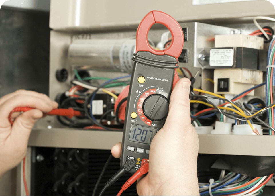 Person using multimeter on electrical panel.