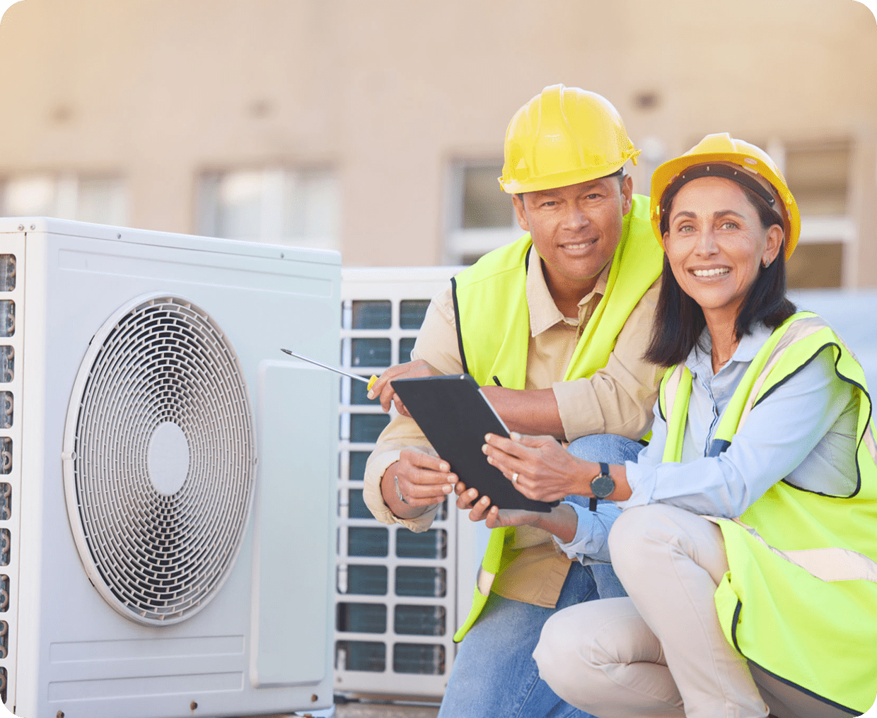 Technicians inspecting air conditioning unit outdoors.