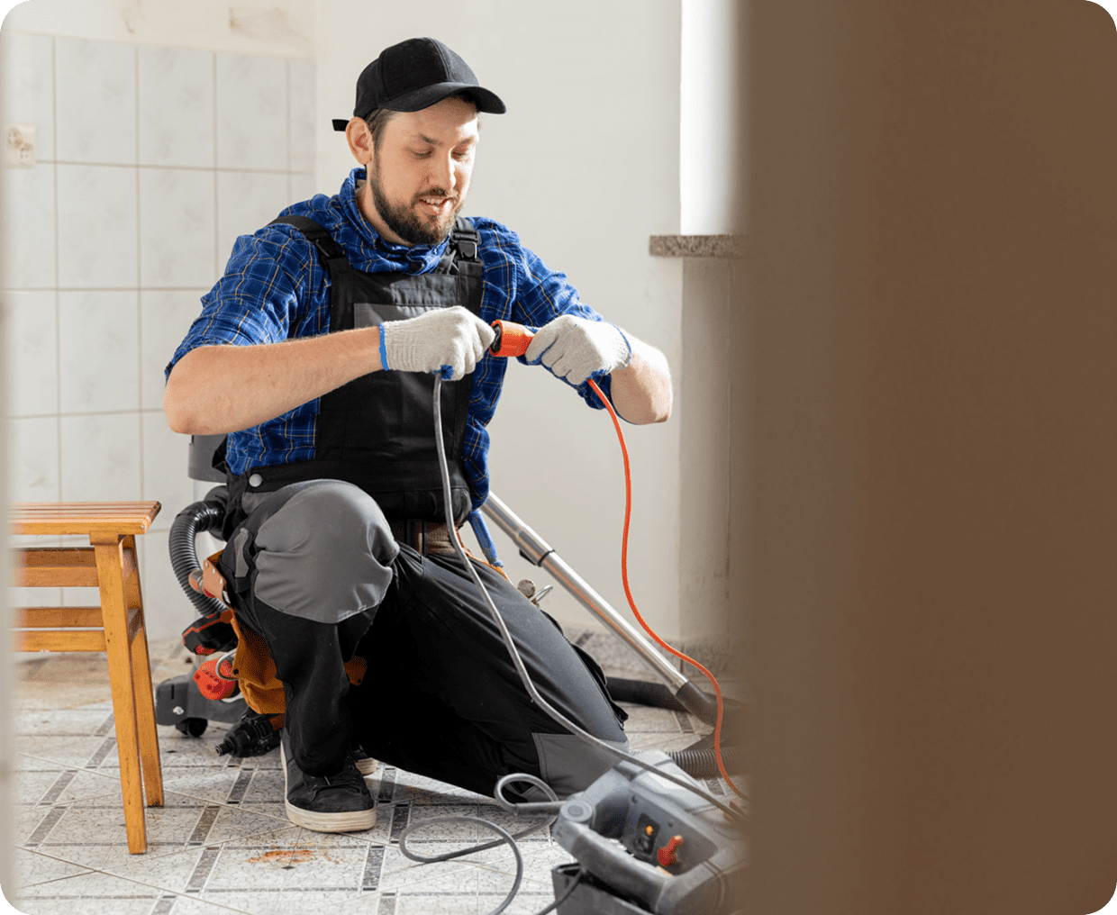 Worker connecting vacuum cleaner on floor.