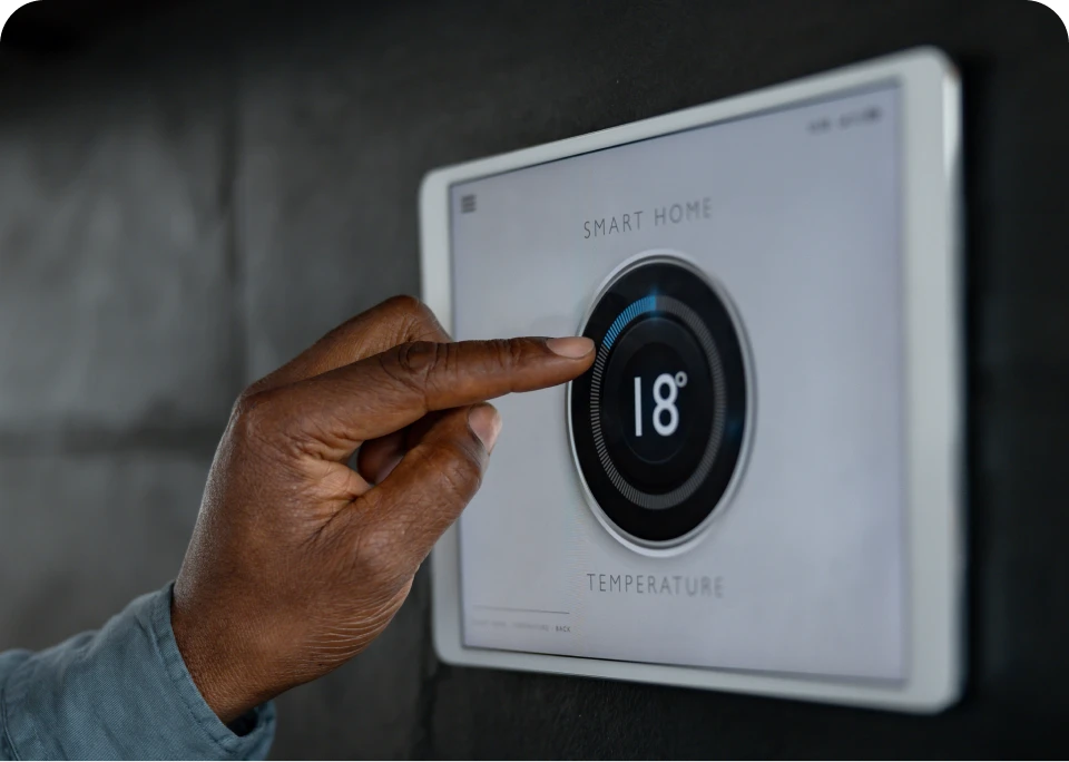 Hand adjusting smart home temperature control.