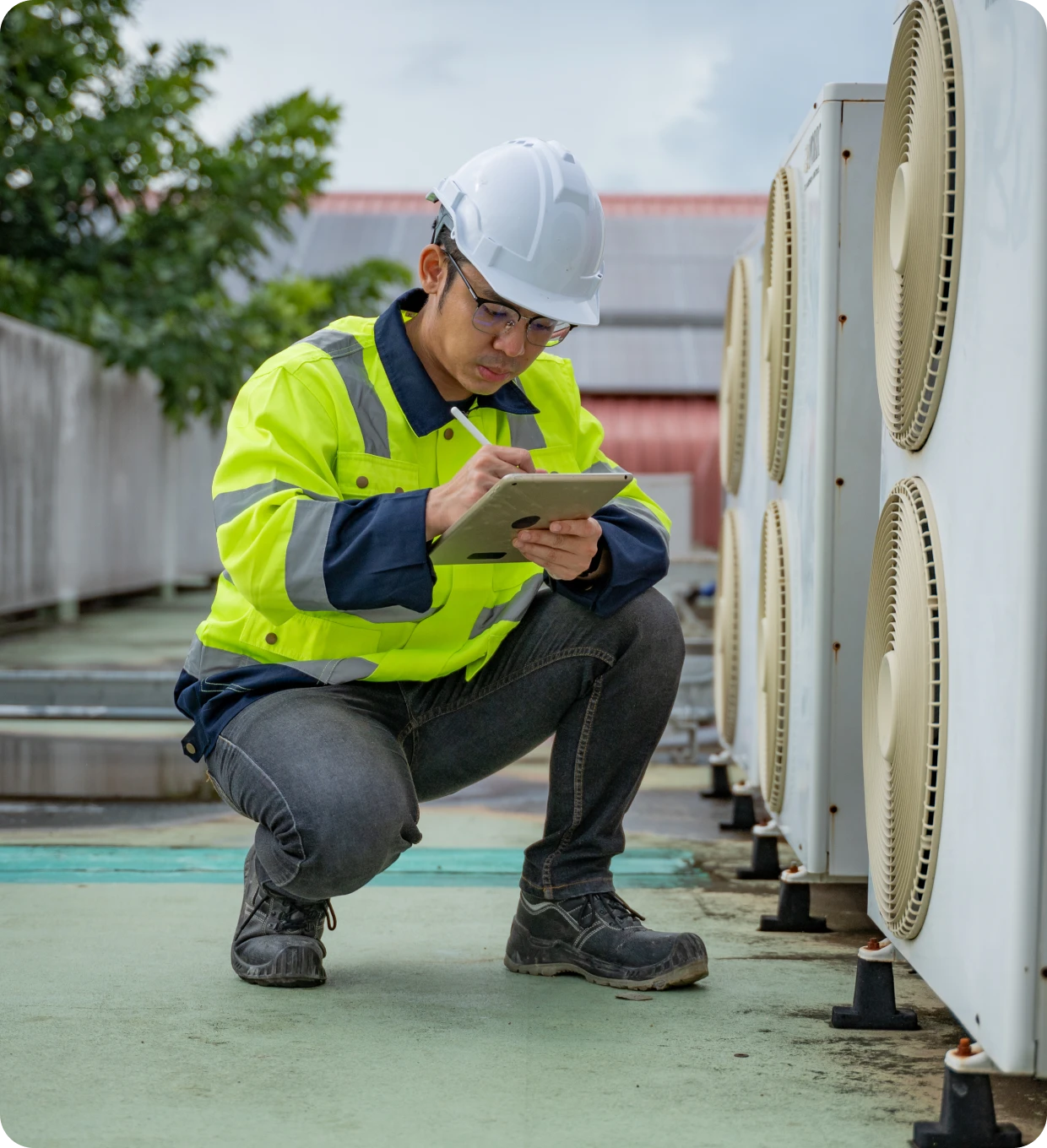 Technician inspecting rooftop air conditioning.