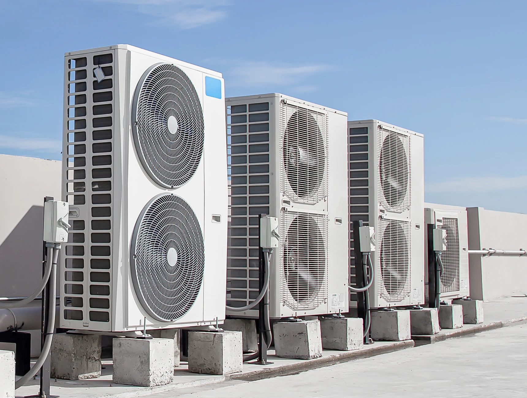 Four rooftop industrial air conditioning units.