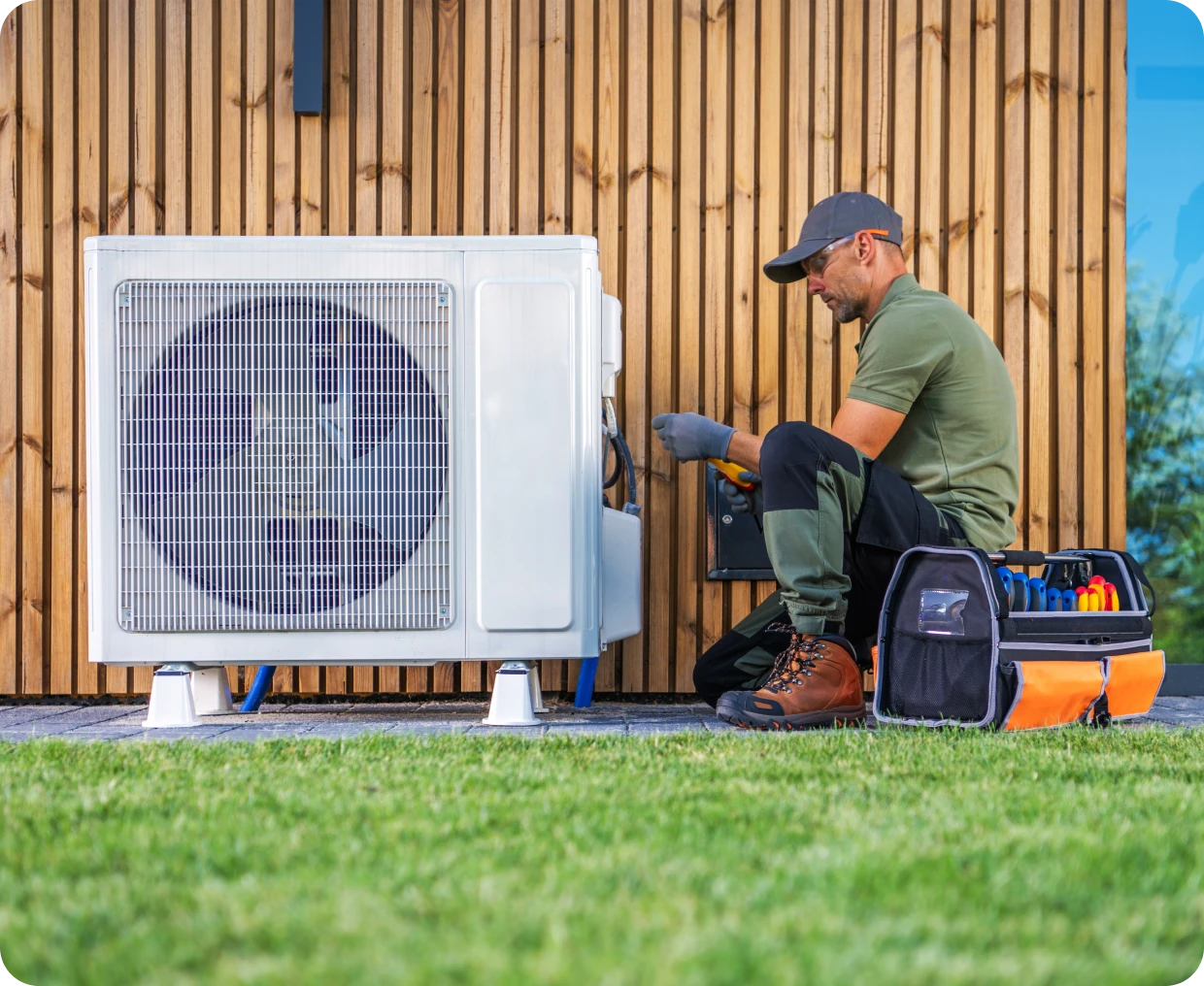 Technician repairing outdoor air conditioning unit.